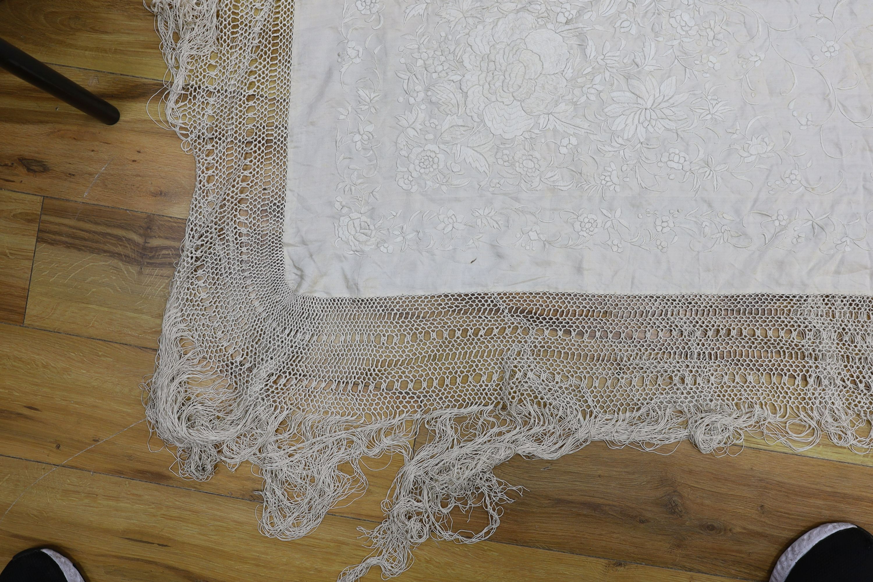 A 19th century cream embroidery on cream silk shawl together with a smaller later shawl